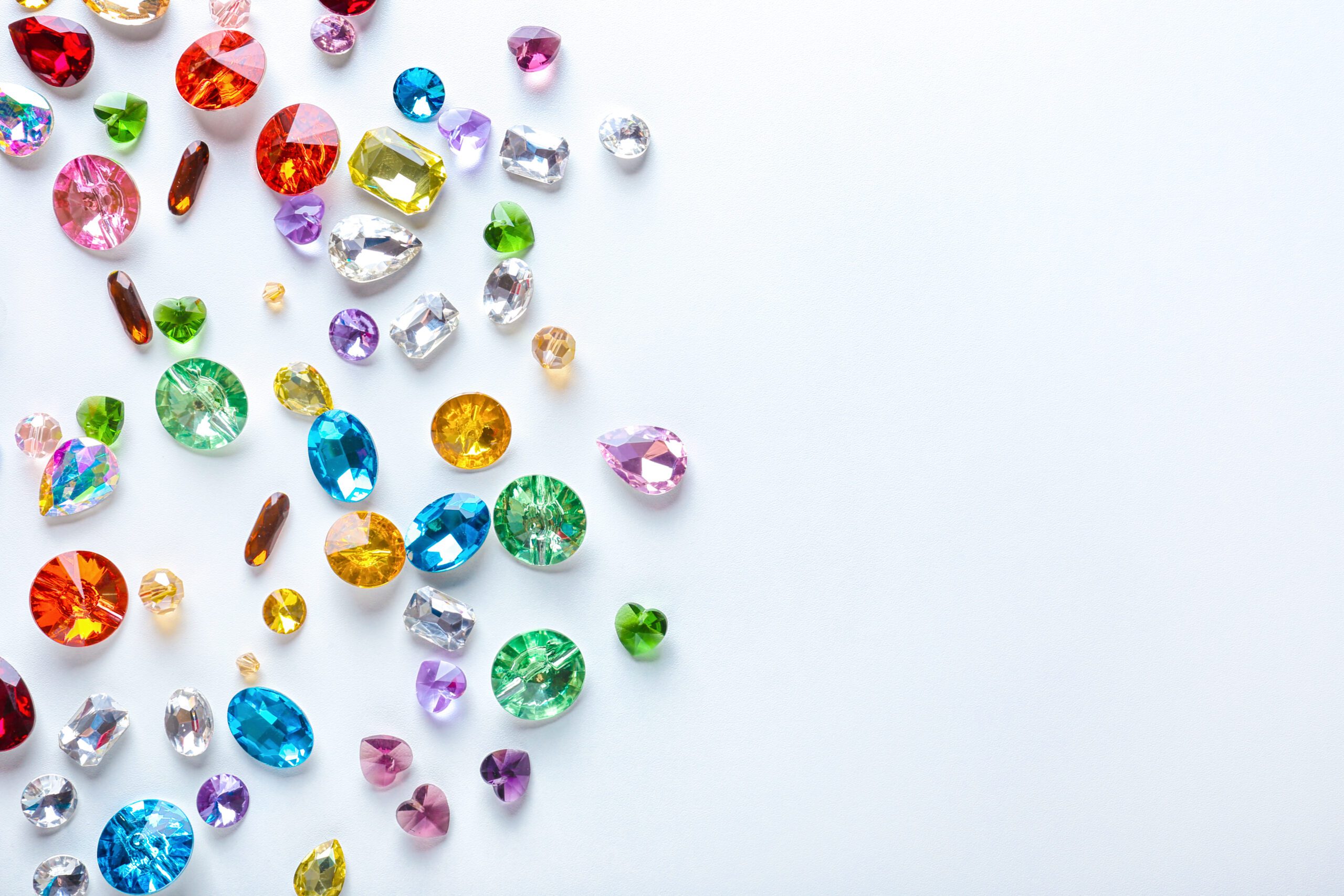 Colourful cut gemstones on a light background